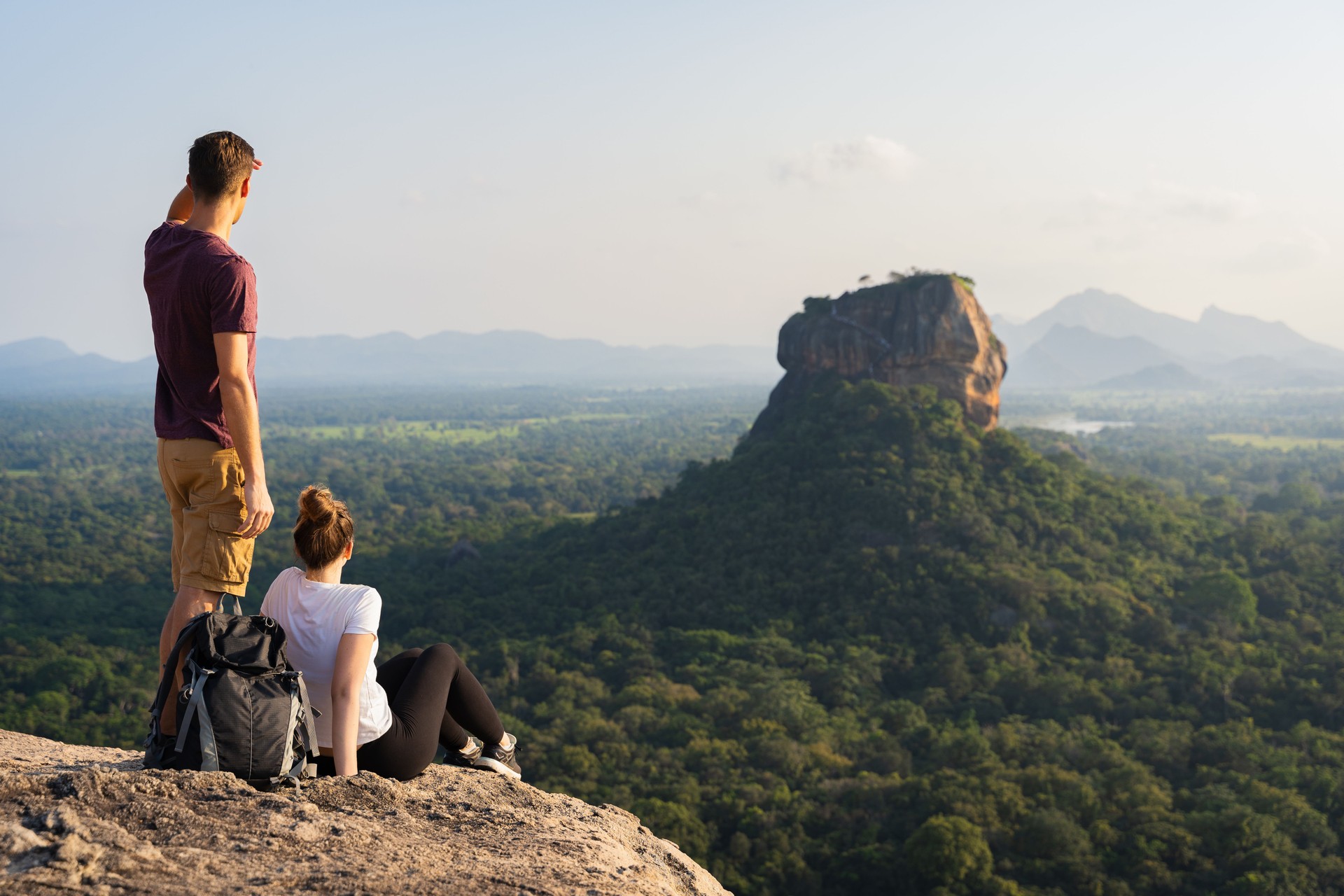 A couple of tourists observing the lion rock on sigiriya